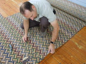 Expert craftsman working on geometric rug